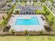 Aerial view of community pool, lounge chairs, covered area, and parking at 7413 Bent Tree Loop, St Cloud, FL 34771