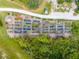 Aerial view of community garden plots surrounded by green spaces and trees at 7413 Bent Tree Loop, St Cloud, FL 34771