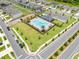 Aerial view of community pool, parking, and landscaped common areas at 7413 Bent Tree Loop, St Cloud, FL 34771