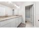 Bathroom featuring double sinks with granite counters, modern lighting, and tile flooring at 7413 Bent Tree Loop, St Cloud, FL 34771