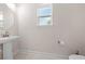 Powder room featuring a pedestal sink, window and ceramic tile flooring at 7413 Bent Tree Loop, St Cloud, FL 34771