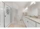 Bright bathroom with double sinks, granite countertops, and a glass-enclosed shower at 7413 Bent Tree Loop, St Cloud, FL 34771