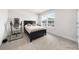 Bright bedroom features a black bed, side table, and inversion table at 7413 Bent Tree Loop, St Cloud, FL 34771