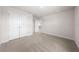 Bright bedroom featuring neutral carpet, white trim and doors, and a walk-in closet at 7413 Bent Tree Loop, St Cloud, FL 34771