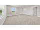 Bright bedroom featuring plush carpeting, a large window, and neutral colors at 7413 Bent Tree Loop, St Cloud, FL 34771