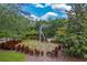 A metal statue surrounded by colorful plants, in a beautifully landscaped roundabout at 7413 Bent Tree Loop, St Cloud, FL 34771