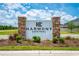 Entrance sign to the Harmony Central community with stone accents and landscaping at 7413 Bent Tree Loop, St Cloud, FL 34771