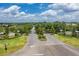 A well-maintained community entrance with mature trees, landscaping, and Harmony sign at 7413 Bent Tree Loop, St Cloud, FL 34771