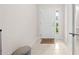 Welcoming foyer features a white door with sidelight, tile flooring, and a view of a bathroom at 7413 Bent Tree Loop, St Cloud, FL 34771