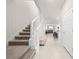 View of the entryway with a staircase, leading to a kitchen and living room at 7413 Bent Tree Loop, St Cloud, FL 34771