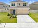 Charming two-story home with well-manicured lawn, and covered front porch at 7413 Bent Tree Loop, St Cloud, FL 34771