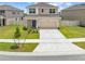 Charming two-story home featuring a two-car garage, well-maintained lawn, and inviting curb appeal at 7413 Bent Tree Loop, St Cloud, FL 34771
