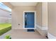 The home features a welcoming blue front door and a 'welcome' mat at 7413 Bent Tree Loop, St Cloud, FL 34771