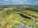 Beautiful aerial view of the golf course featuring manicured greens, water hazards, and surrounding scenery at 7413 Bent Tree Loop, St Cloud, FL 34771