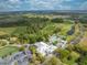Extensive aerial view of the golf course, community center, pool, and surrounding greenspace at 7413 Bent Tree Loop, St Cloud, FL 34771