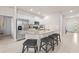 Kitchen with white cabinets, granite countertops, stainless steel appliances, and breakfast bar seating at 7413 Bent Tree Loop, St Cloud, FL 34771