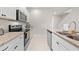 Modern kitchen featuring granite countertops, stainless steel appliances, and white cabinetry at 7413 Bent Tree Loop, St Cloud, FL 34771