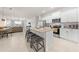 Modern eat-in kitchen with white cabinets, stainless steel appliances, and a granite countertop island with barstool seating at 7413 Bent Tree Loop, St Cloud, FL 34771
