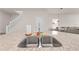 Close-up of the granite kitchen island sink and white staircase at 7413 Bent Tree Loop, St Cloud, FL 34771