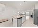 Bright kitchen features a granite island, stainless steel appliances, and an open layout to the living area at 7413 Bent Tree Loop, St Cloud, FL 34771