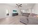 Spacious living room with wood floors, a sectional sofa, and access to an outdoor patio at 7413 Bent Tree Loop, St Cloud, FL 34771