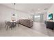 Open living space with combined dining area featuring modern furniture and finishes at 7413 Bent Tree Loop, St Cloud, FL 34771