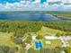 Gorgeous aerial view showcasing the neighborhood park, featuring recreation spaces, lush greenery and blue skies at 7413 Bent Tree Loop, St Cloud, FL 34771