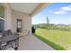Outdoor patio that overlooks a spacious backyard with lush green grass at 7413 Bent Tree Loop, St Cloud, FL 34771