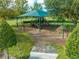 Shaded playground with swings, slides, and climbing structures on a mulch surface at 7413 Bent Tree Loop, St Cloud, FL 34771