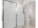 Modern bathroom features a glass-enclosed shower with white tile at 7413 Bent Tree Loop, St Cloud, FL 34771