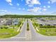 Street view of a well-maintained residential community lined with trees and sidewalks at 7413 Bent Tree Loop, St Cloud, FL 34771