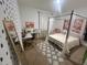 Stylized bedroom featuring a four-poster bed, desk, and patterned wallpaper, ideal for relaxation and study at 820 Cambridge Dr, Winter Haven, FL 33881