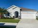 Charming single-story home with a well-manicured lawn and a two-car garage on a sunny day at 820 Cambridge Dr, Winter Haven, FL 33881