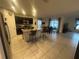 Open-concept kitchen with dark cabinetry, granite countertops, and modern appliances, adjacent to the dining area at 820 Cambridge Dr, Winter Haven, FL 33881