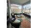 Relaxing outdoor patio with comfortable seating, a colorful rug, and a relaxing hammock for enjoying the fresh air at 820 Cambridge Dr, Winter Haven, FL 33881