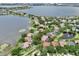 Aerial view of lakeside homes circled in red with a large lake, fountains and greenery in the background at 8214 Lake Serene Dr, Orlando, FL 32836