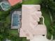 An aerial view shows a terracotta roofed house with a screened in pool in a meticulously landscaped backyard at 8214 Lake Serene Dr, Orlando, FL 32836