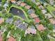 An aerial view shows a community with ponds, green spaces and well maintained homes with terracotta roofs at 8214 Lake Serene Dr, Orlando, FL 32836