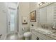 Well-lit bathroom with a granite countertop vanity, decorative mirror, and a separate shower at 8214 Lake Serene Dr, Orlando, FL 32836