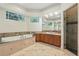 Bright bathroom with natural light, a soaking tub, a walk-in shower, and ample vanity space at 8214 Lake Serene Dr, Orlando, FL 32836