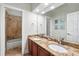 Bathroom featuring a double vanity with a granite countertop and separate tiled shower at 8214 Lake Serene Dr, Orlando, FL 32836
