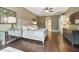 Bedroom with hardwood floors, a tufted headboard, and art at 8214 Lake Serene Dr, Orlando, FL 32836