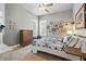 Cozy bedroom with carpet, window views, a dresser, and curated art at 8214 Lake Serene Dr, Orlando, FL 32836
