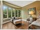 Bedroom seating area with large windows overlooking a beautiful view of greenery at 8214 Lake Serene Dr, Orlando, FL 32836