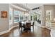 Charming breakfast nook with large windows, stylish chandelier, and view of the pool at 8214 Lake Serene Dr, Orlando, FL 32836