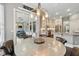Unique breakfast nook with custom chandelier, access to the kitchen, and outdoor patio views at 8214 Lake Serene Dr, Orlando, FL 32836