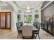 Elegant dining room with natural light, beautiful chandelier, and a table with seating for eight at 8214 Lake Serene Dr, Orlando, FL 32836