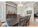 Open dining room with decorative black wood chairs surrounding a beautiful wood table with an overhead chandelier at 8214 Lake Serene Dr, Orlando, FL 32836