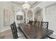 This spacious dining room is framed by elegant columns and features a dark wood table at 8214 Lake Serene Dr, Orlando, FL 32836