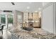 Spacious kitchen showcasing granite countertops, premium appliances, and access to the outdoor patio at 8214 Lake Serene Dr, Orlando, FL 32836